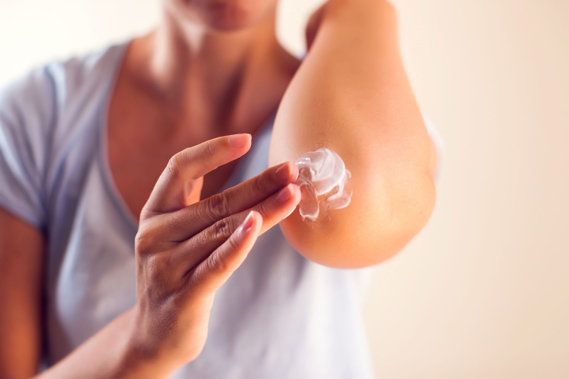 Woman,Applies,Cream,On,Her,Elbow.people,,Healthcare,And,Medicine,Concept